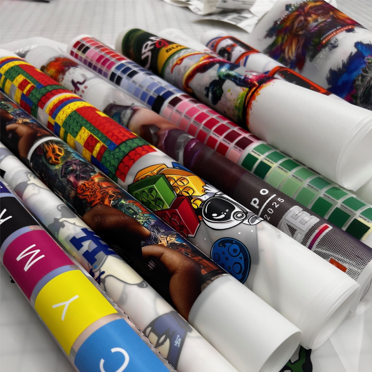 Colorful rolls of DTF custom transfers showcasing vibrant designs and patterns, offered by Printomize America, highlighting the versatility and variety available in their DTF Custom Transfers (46inch).
