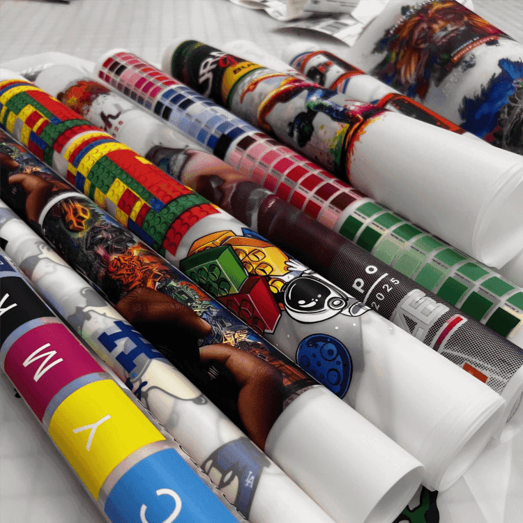 Colorful rolls of DTF custom transfers showcasing vibrant designs and patterns, offered by Printomize America, highlighting the versatility and variety available in their DTF Custom Transfers (46inch).