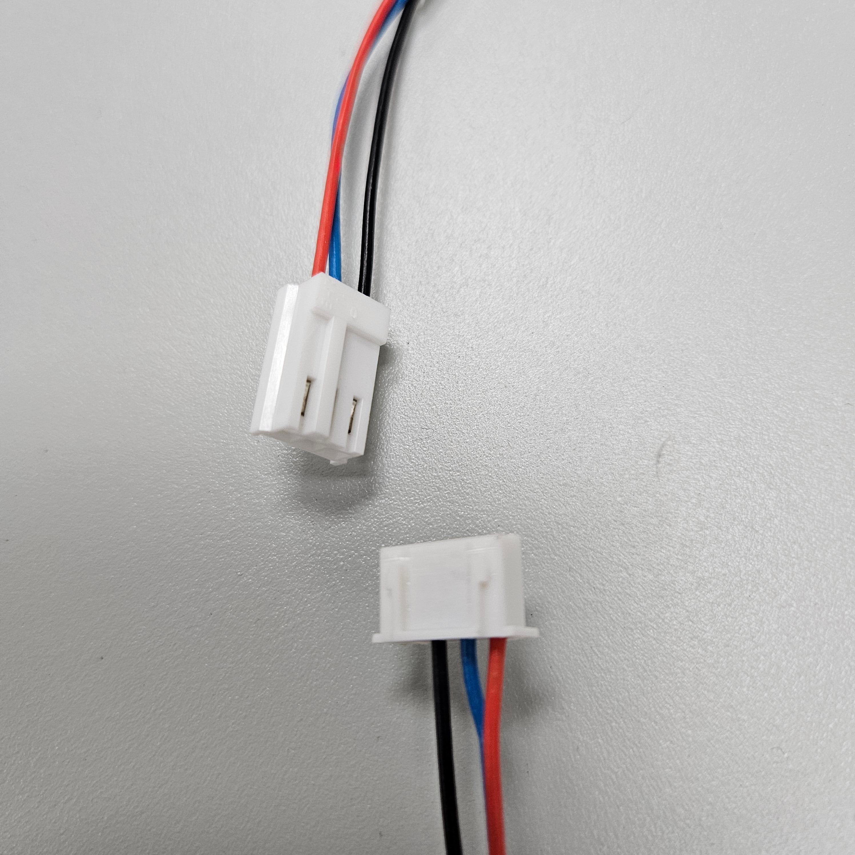 Close-up of connectors on the End Stop Sensor Cable by Printomize America, displaying the wiring configuration with red, black, and blue wires, essential for DTF printer connectivity.